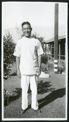 Photograph of smiling male hospital staff posing in front of the Manzanar hospital