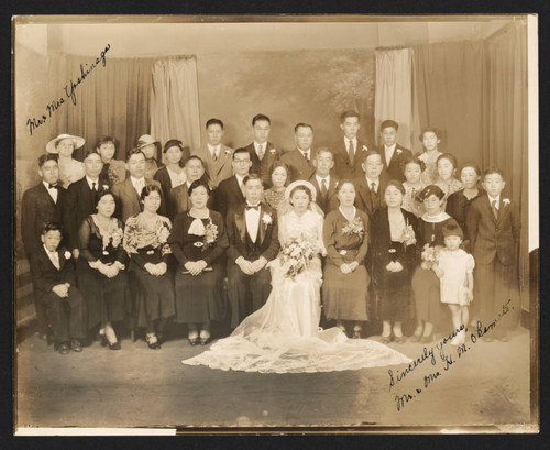 Wedding portrait of Mr. and Mrs. N.M. Okimato with guests