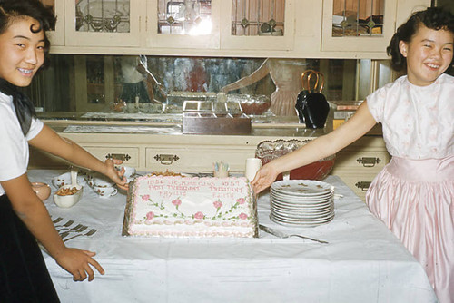 Girls holding a cake at Jr. Miss event