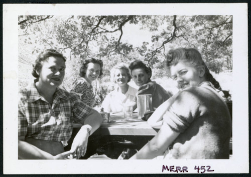 Photograph of five women sitting around a picnic bench, including Lucy Adams, Gertrude Wetzel, Bernice Sibner, and Lucy Wilcox