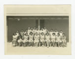 Group of Nisei 8th graders with a teacher outside a barrack