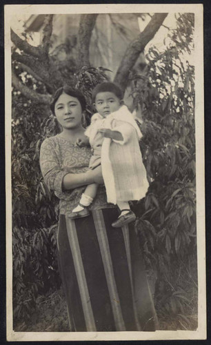 Woman holding a child outside