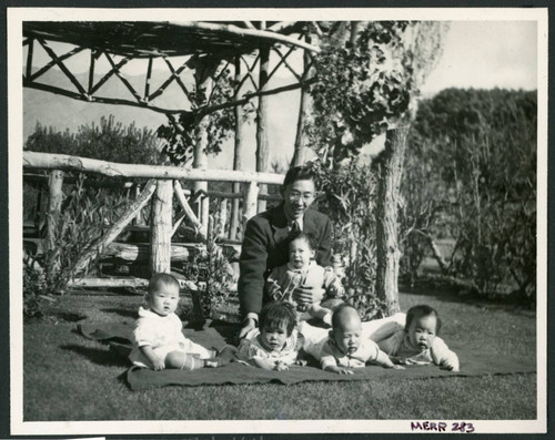 Photograph of Henry Matsumoto with orphan incarcerees at Children's Village