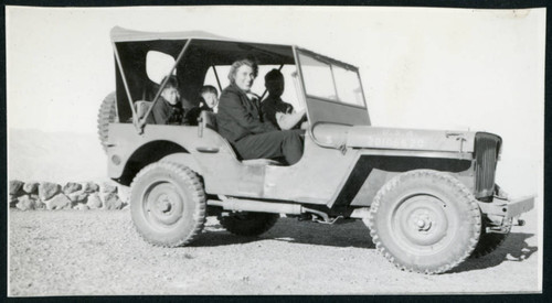 Photograph of L. Josephine Hawes and three others sitting in an Army jeep in Death Valley