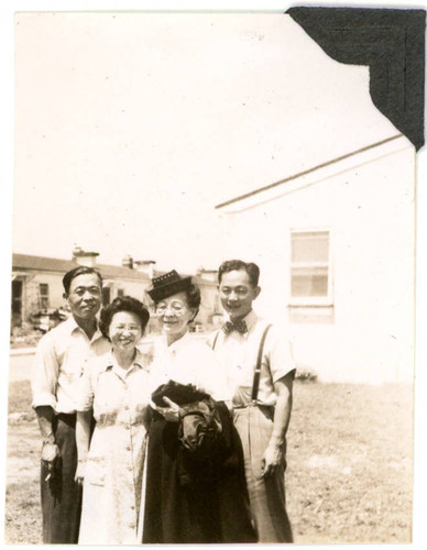 Frank, Shigeru, and John Yoshinaga standing next to woman