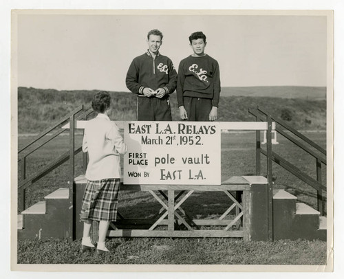 Two young men on podium for East Los Angeles relays