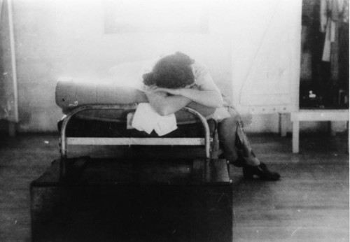 [Girl resting in Children's Village barrack]