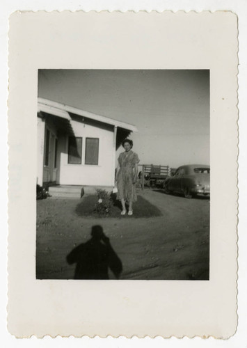 Kiyoko Maeda Yoshioka in front of newly purchased home and farmland