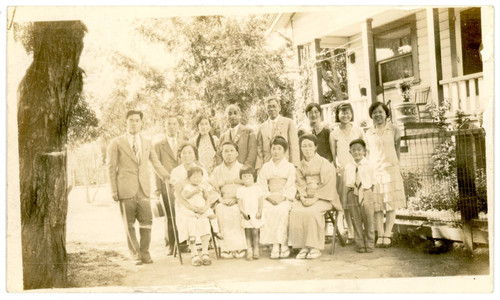 Yoshinaga and Narita family in front of Yoshinaga house