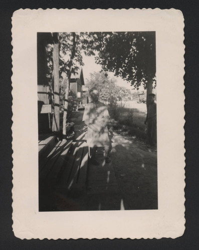 Elderly woman in the shadow of trees