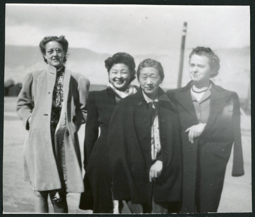 Photograph of Yone Akite and Lucille Carney standing in front of the Sierra Nevada