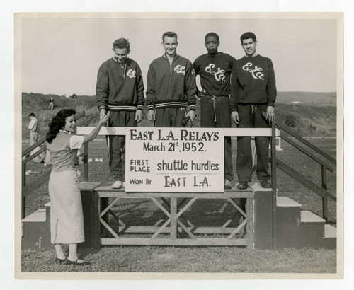 Four young men on podium for East Los Angeles relays