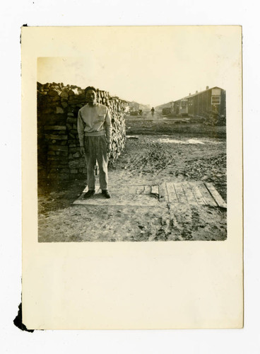 Man with woodpile in Jerome camp