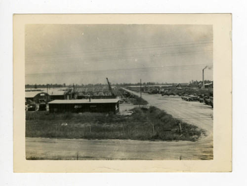 Motor pool with smokestack in Jerome camp