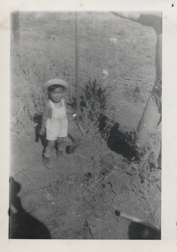 Toddler holds a shovel