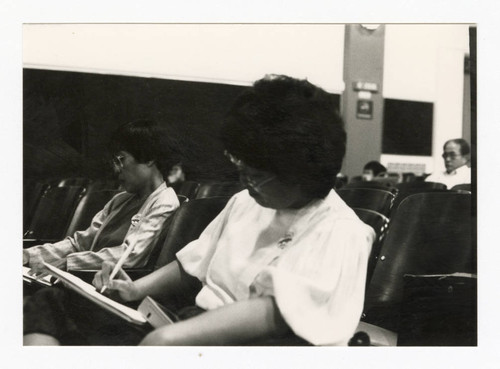 Women taking notes at Senate hearing on Senate bill 2116