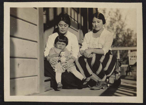 Women and child on porch