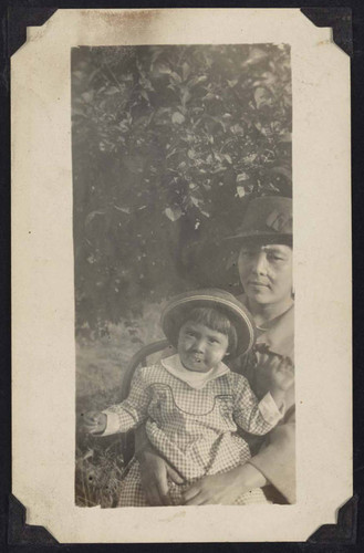 Woman and young girl under tree