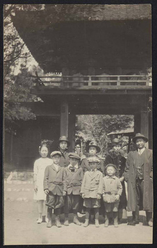 Group of men, women, and children in doorway