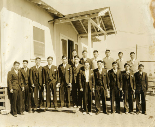 Formally Dressed Men in front of a House