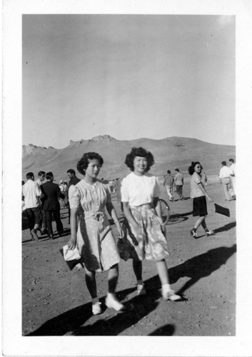 [Two women walking]