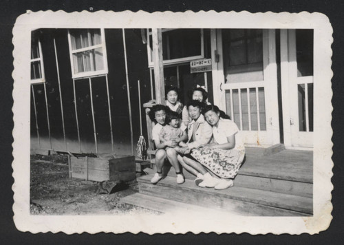 Four females and Hiroshi Takemoto's daughter, Jean, in front of H. Takemoto barrack 42-07-C