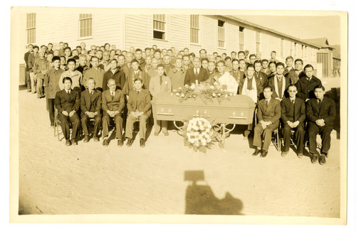 Smaller group of people at funeral in an incarceration camp