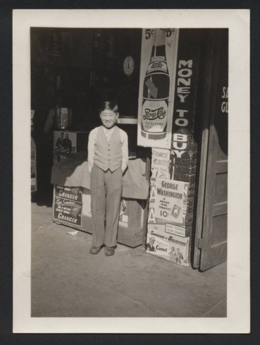 Boy standing in front of store