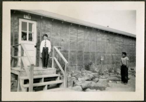 Boy standing on barrack stairs