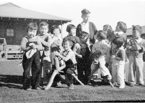 [Children playing on structure in Children's Village]