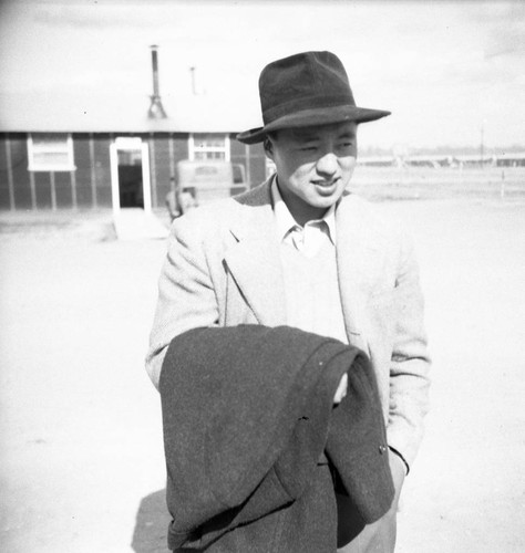 Nisei man in hat with coat in Jerome camp