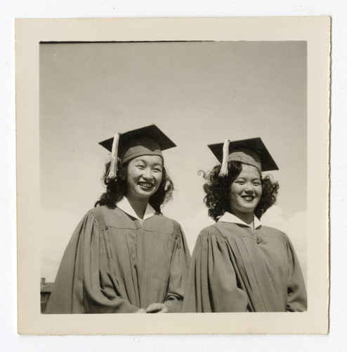 Kazuko Katherine Saito and Hisayo wearing caps and gowns at Heart Mountain