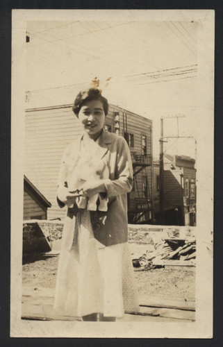 Yasuno (Yasuko) Ikuma standing on top of a house in Japanese Alley