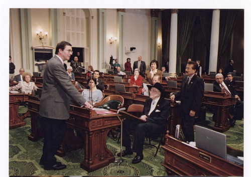 Kevin Shelley at podium in assembly chamber