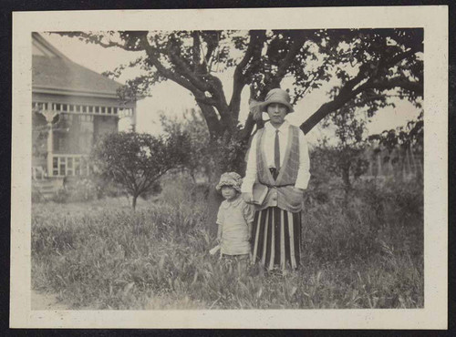 Mother and daughter underneath a tree