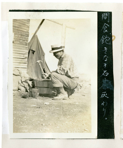 Nisei man crushing coals