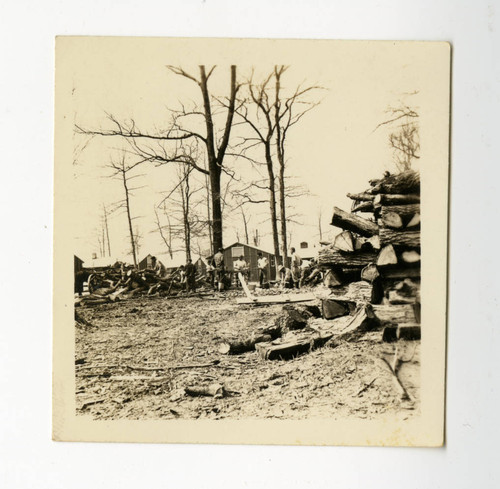 Men chopping wood for barracks' heating system