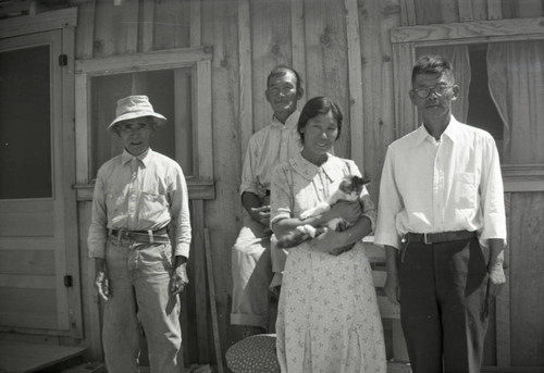 Three men, one woman with cat