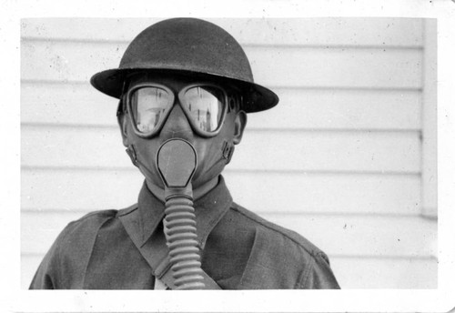 [Toshikuni Taenaka in US Army uniform with gas mask]