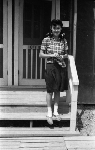 Woman by office door in Jerome camp