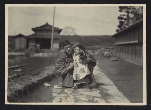 Man kneeling besides child