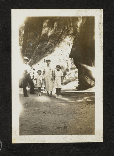 Man, woman, and two girls standing