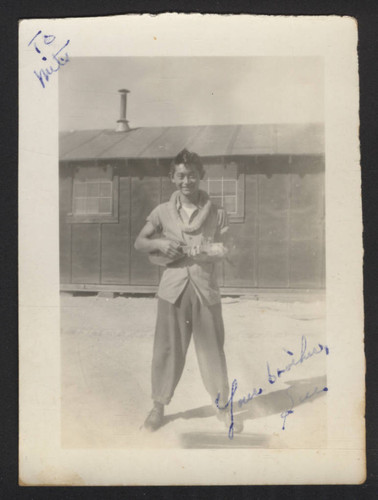 Suenari Koyasako strumming a ukulele at Tule Lake