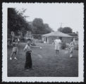 Lisa Furutani and David Abe with two children playing badminton