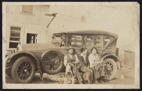 People sitting in front of car