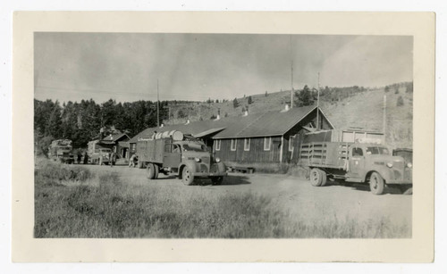 War Relocation Authority trucks in front of barrack