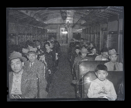 Large group of Japanese American people from Terminal Island fill a vehicle during "evacuation"