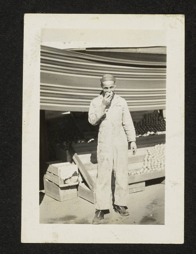 Man standing in front of fruit stand