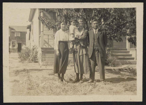 Women, man, and child on farm