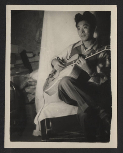 Kazuo "Jackson" Koyasako playing guitar at Tule Lake